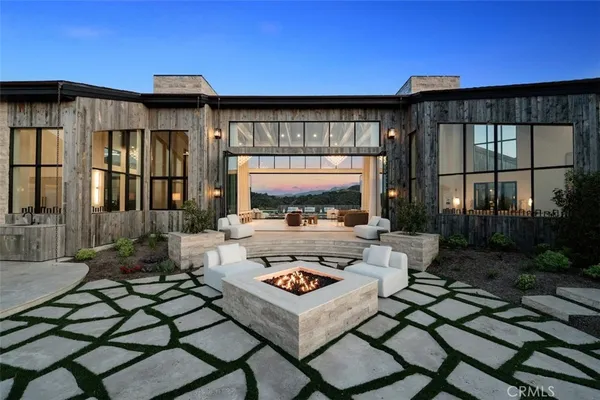 a living room with patio furniture and a large window