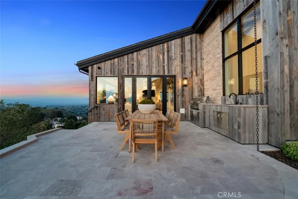 a balcony with chairs and a table