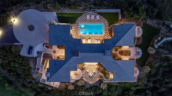 an aerial view of a house with outdoor space pool seating area and yard