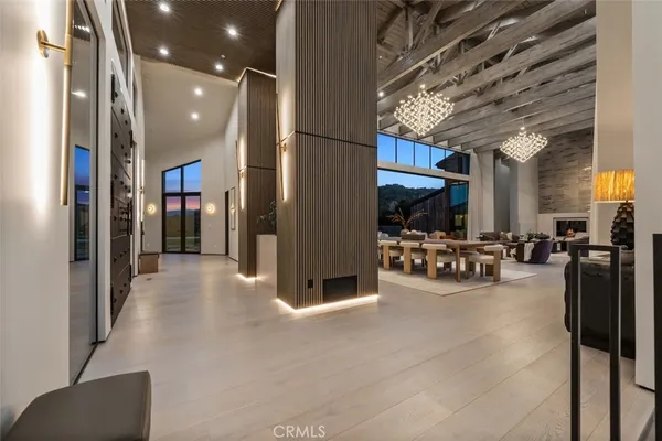 a view of a hallway with livingroom and furniture