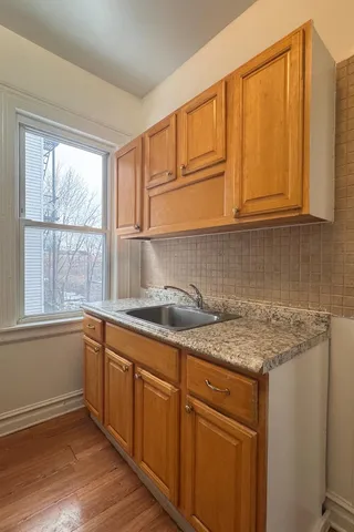 a kitchen with a sink window and cabinets