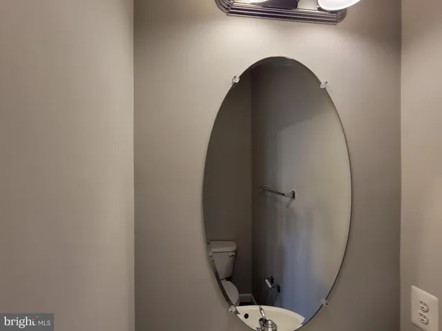 a view of a livingroom with a chandelier fan and a bathroom