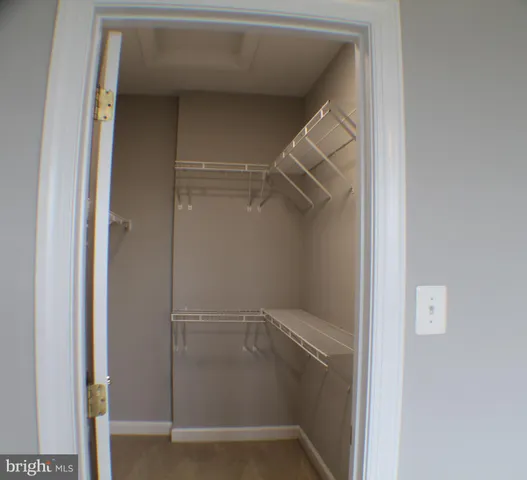 an empty room with a empty space and a ceiling fan