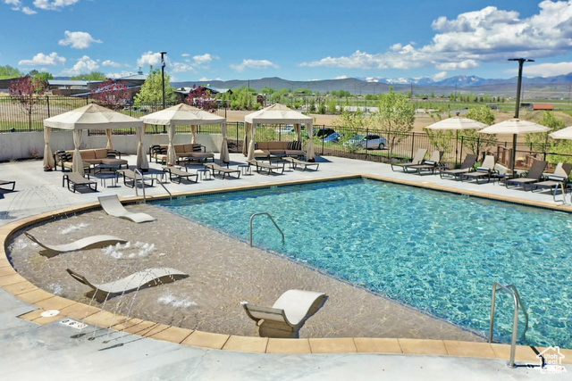 883 Wasatch View Drive, Unit 11 Kamas, UT 84036 - Photo 8 of 14 Community pool with a gazebo, a mountain view, outdoor lounge area, and a patio area