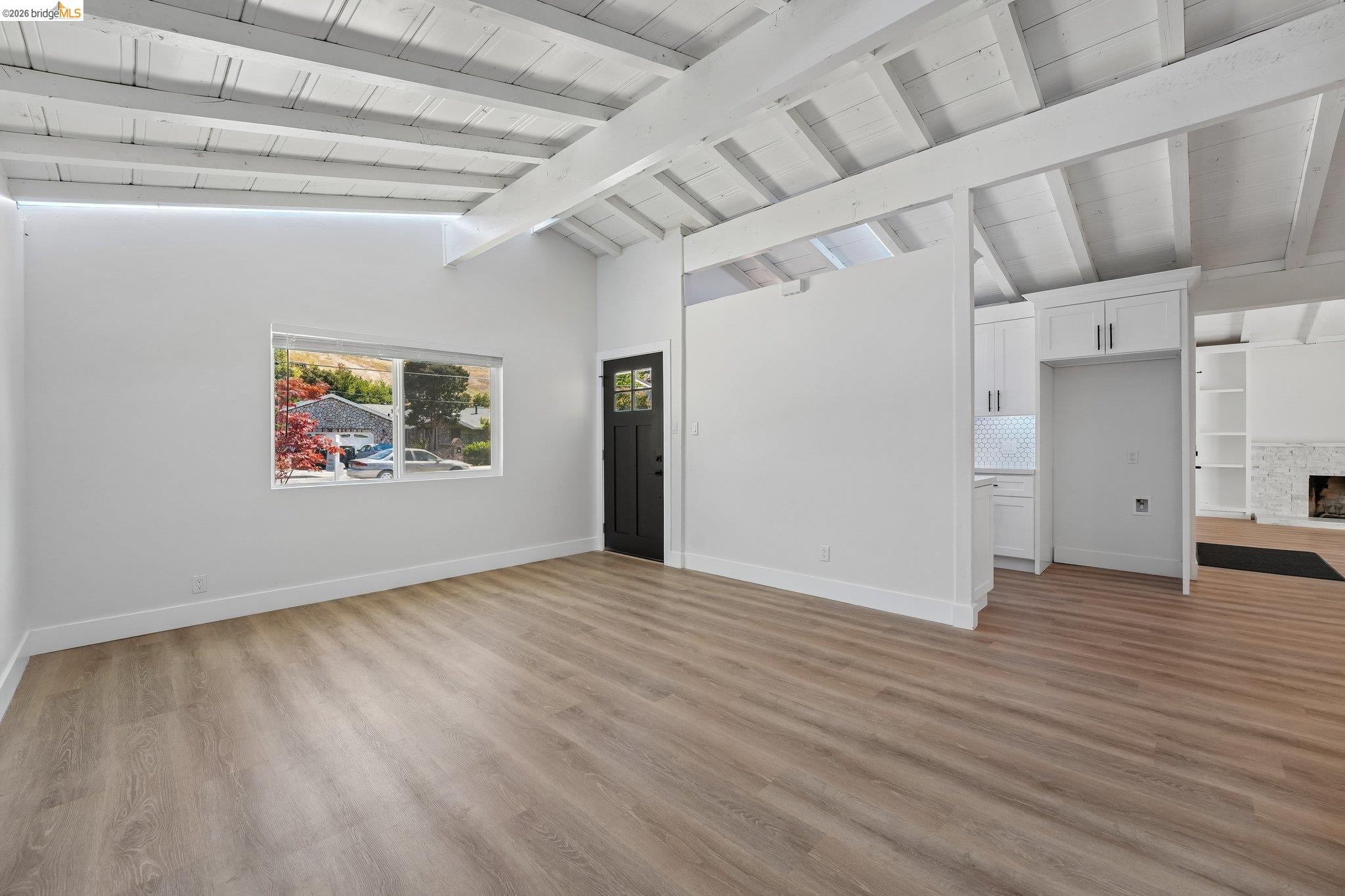 375 Senter Road San Jose, CA 95111 - Photo 8 of 80 a view of an empty room with a window and wooden floor