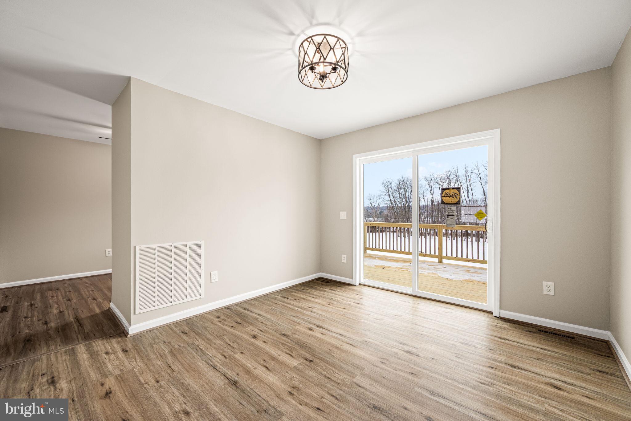 3096 Upper Valley Road Parkesburg, PA 19365 - Photo 11 of 31 a view of an empty room with wooden floor and a window