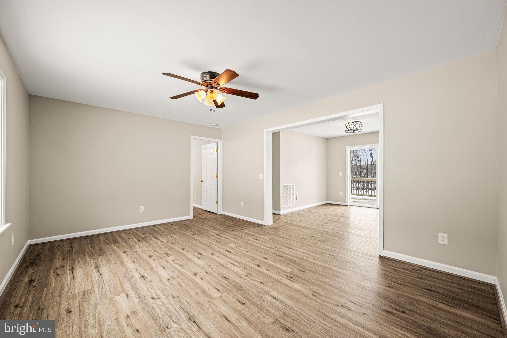 3096 Upper Valley Road Parkesburg, PA 19365 - Photo 15 of 31 a view of an empty room with window and wooden floor