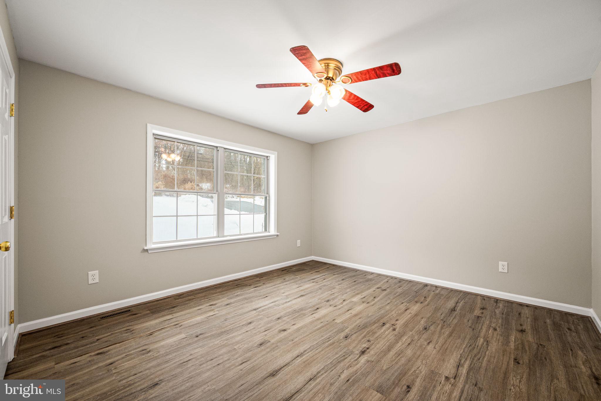 3096 Upper Valley Road Parkesburg, PA 19365 - Photo 17 of 31 a view of an empty room with wooden floor and a window