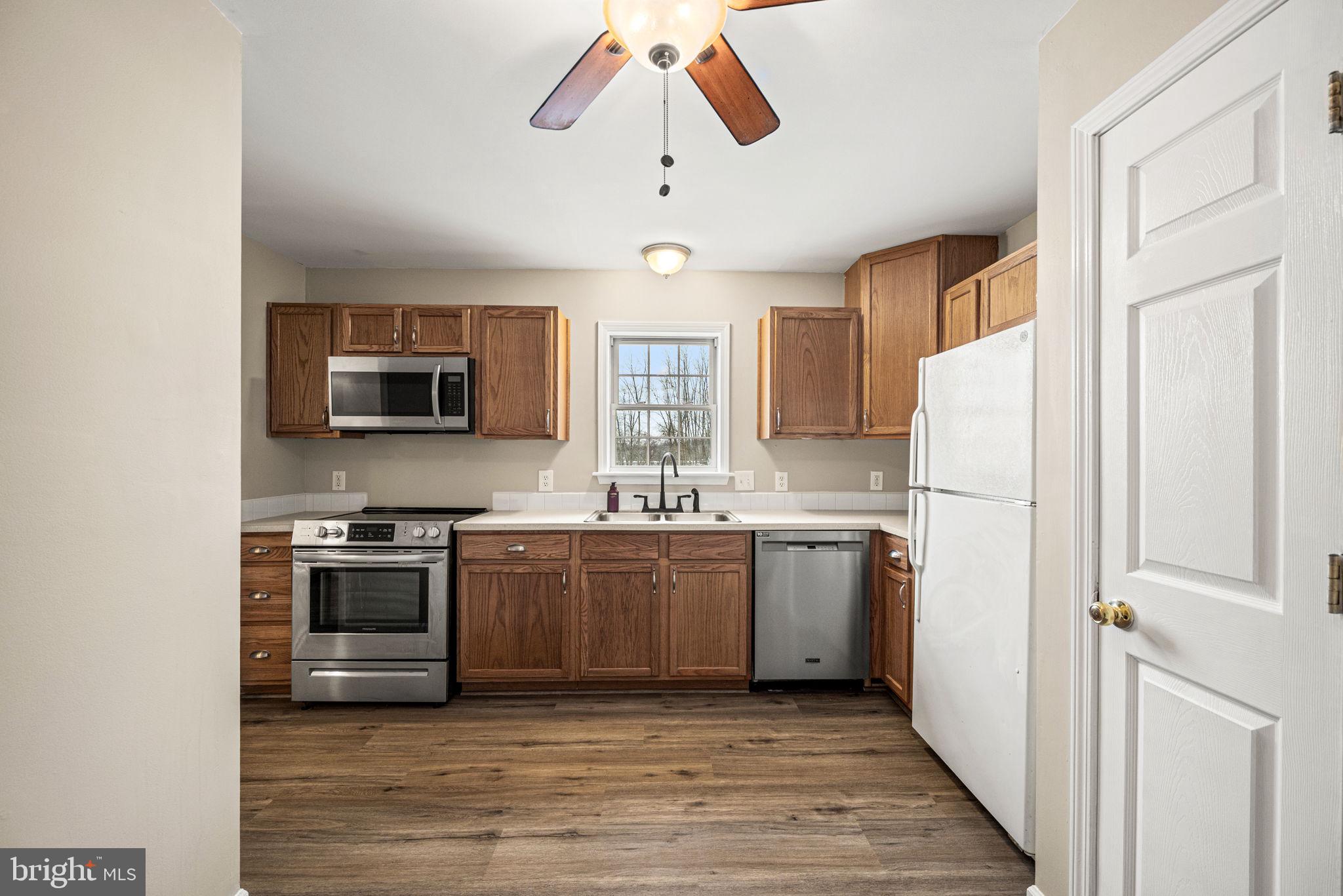 3096 Upper Valley Road Parkesburg, PA 19365 - Photo 7 of 31 a kitchen with stainless steel appliances granite countertop a refrigerator a stove a sink and a microwave