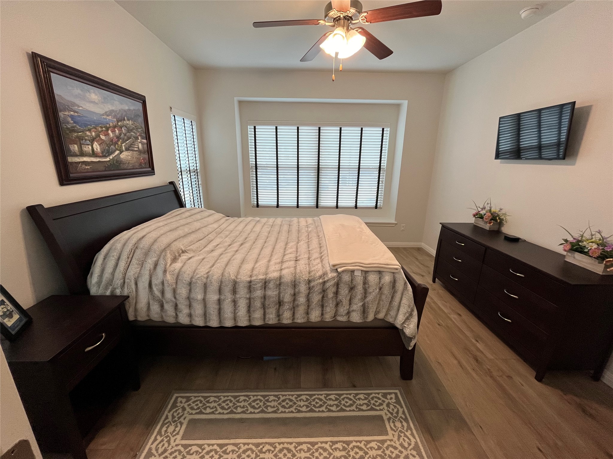 8145 Daisy Cutter Crossing Georgetown, TX 78626 - Photo 11 of 25 Bedroom featuring wood-finish flooring, a ceiling fan with integrated lighting, and a window with horizontal blinds
