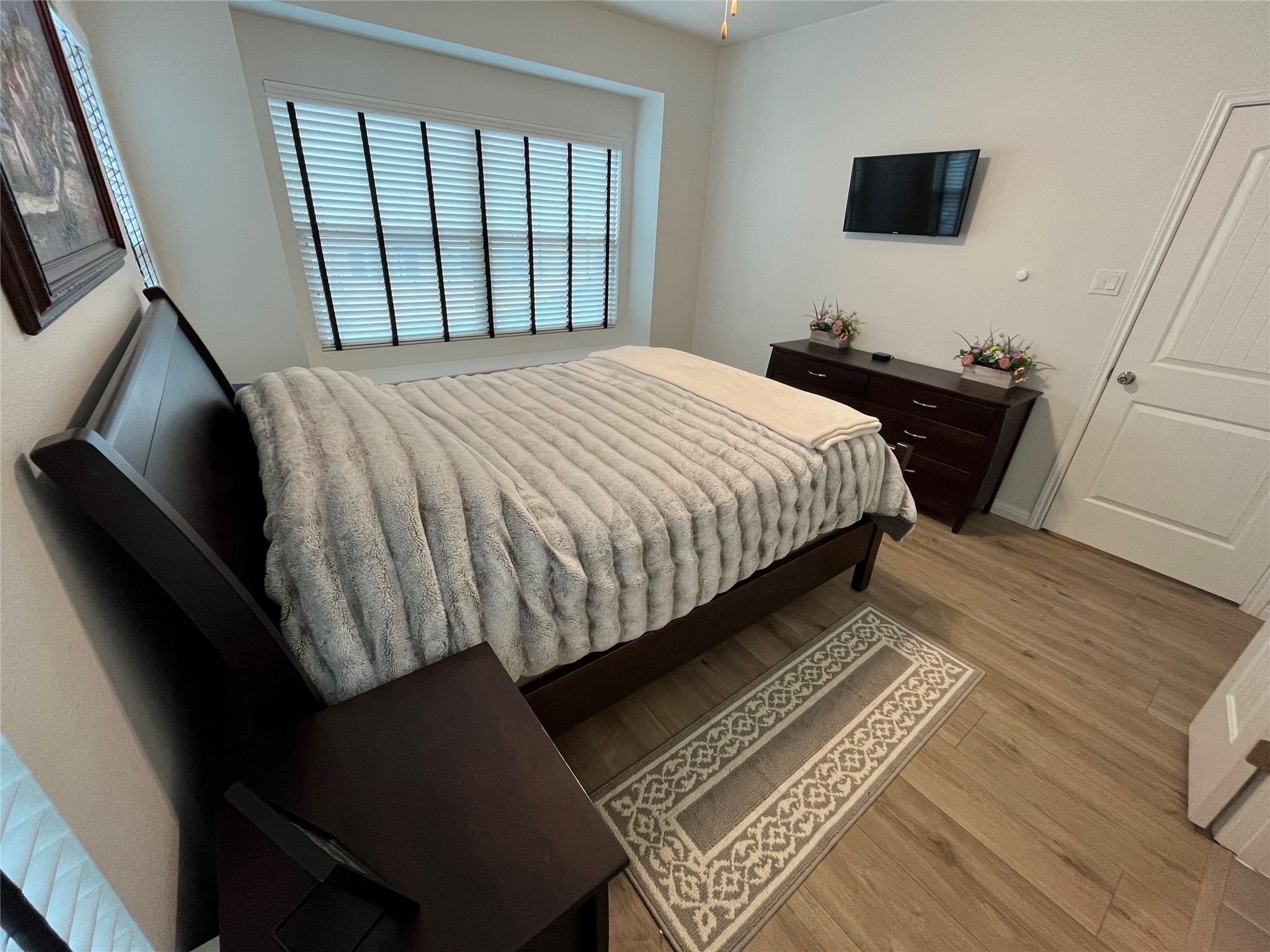 8145 Daisy Cutter Crossing Georgetown, TX 78626 - Photo 12 of 25 Bright interior space featuring wood-finish flooring, a ceiling fan, and a window with horizontal blinds