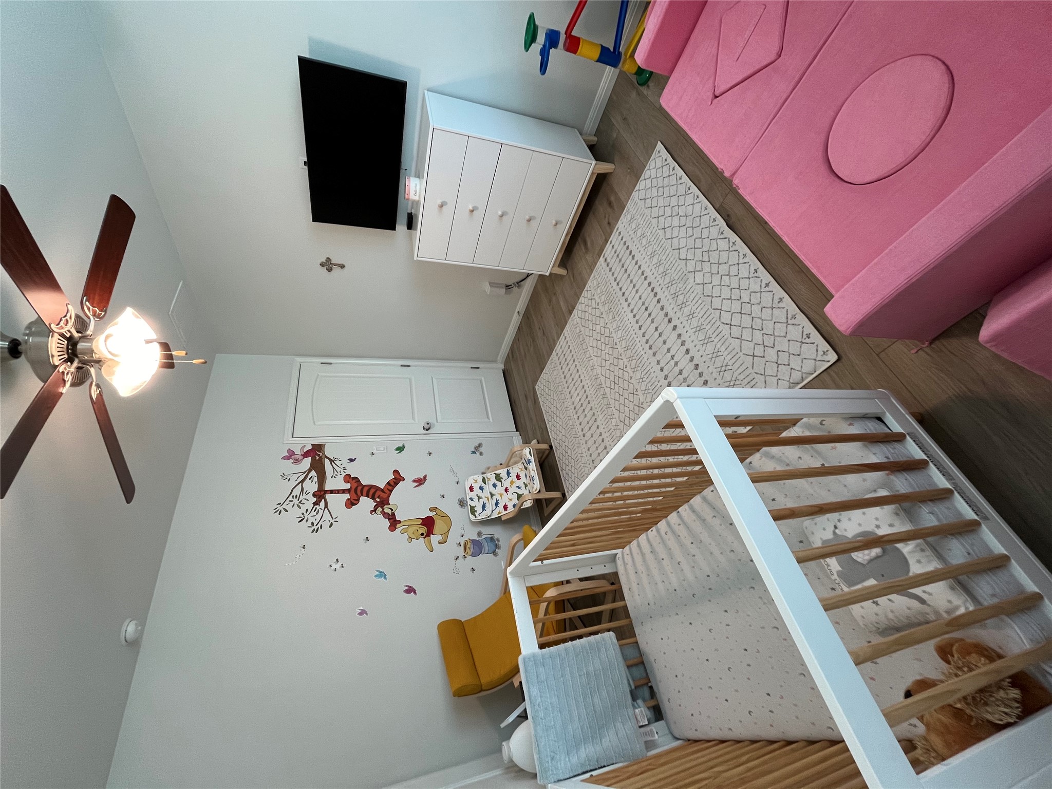 8145 Daisy Cutter Crossing Georgetown, TX 78626 - Photo 18 of 25 Interior room featuring wood-finish flooring, a ceiling fan with light fixture, and a solid-core door