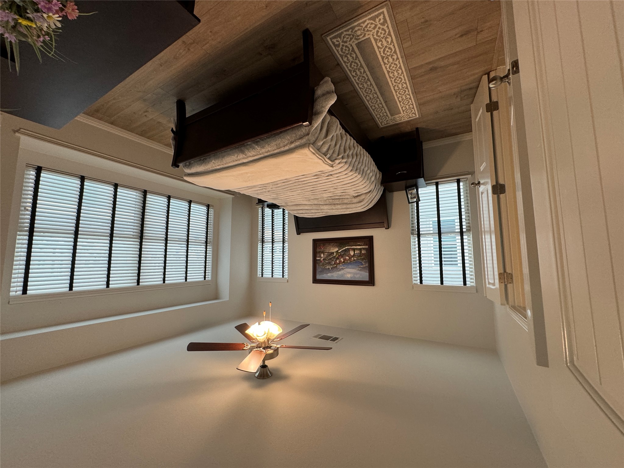 8145 Daisy Cutter Crossing Georgetown, TX 78626 - Photo 10 of 25 Room featuring wood-finish flooring, a ceiling fan with light fixture, and multiple windows with horizontal blinds