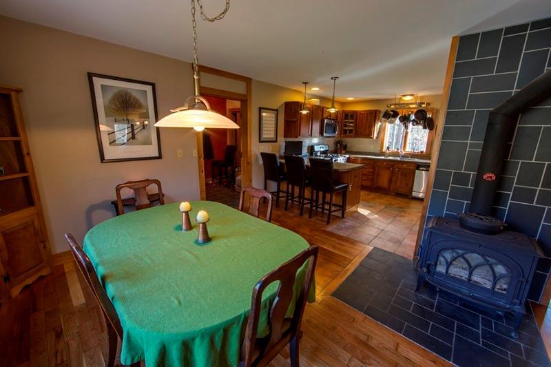 176 Baker Road Bethel, ME 04217 - Photo 10 of 29 Dining room and kitchen with wood stove