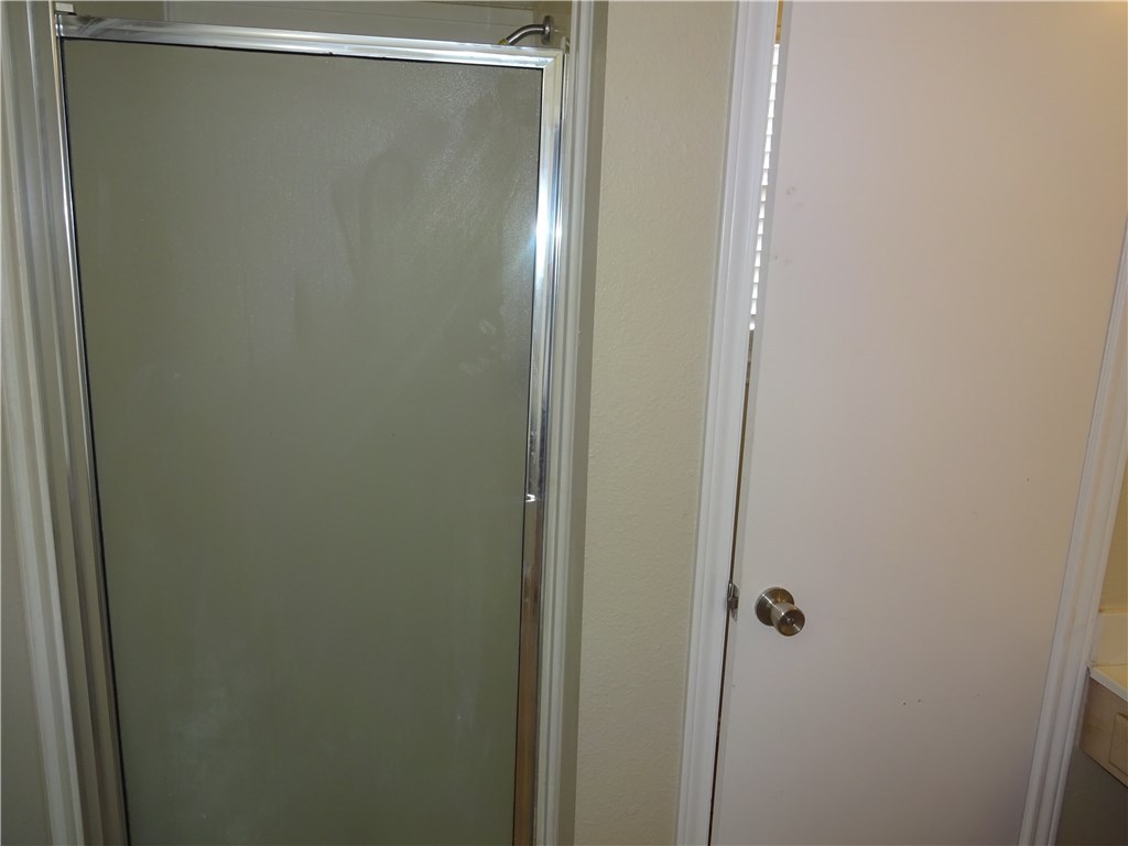 Undisclosed Address Corpus Christi, TX 78414 - Photo 11 of 16 a bathroom with a glass shower door