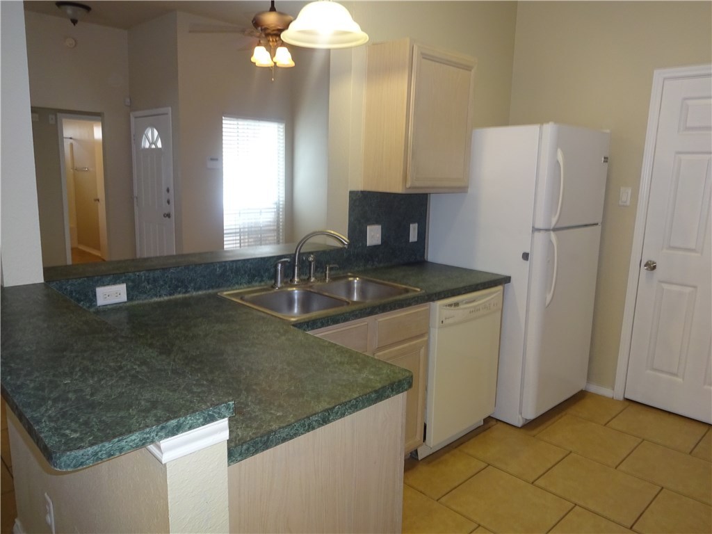 Undisclosed Address Corpus Christi, TX 78414 - Photo 6 of 16 a kitchen with a sink granite counter tops and a view of living room