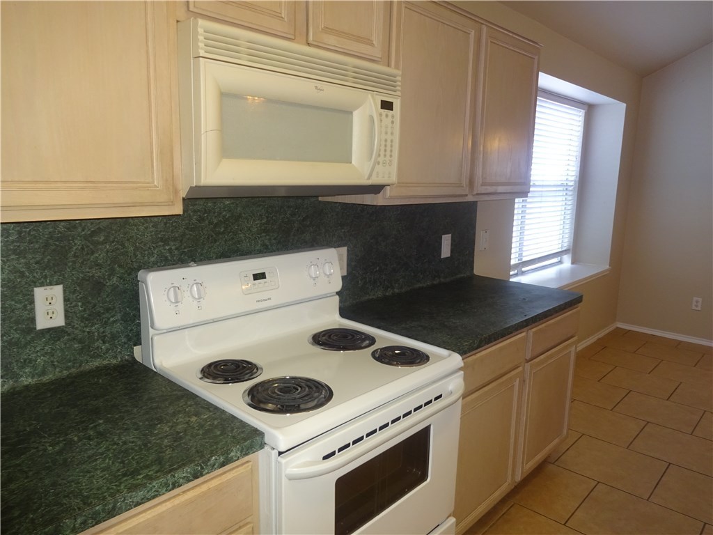 Undisclosed Address Corpus Christi, TX 78414 - Photo 7 of 16 a kitchen with a stove and a microwave