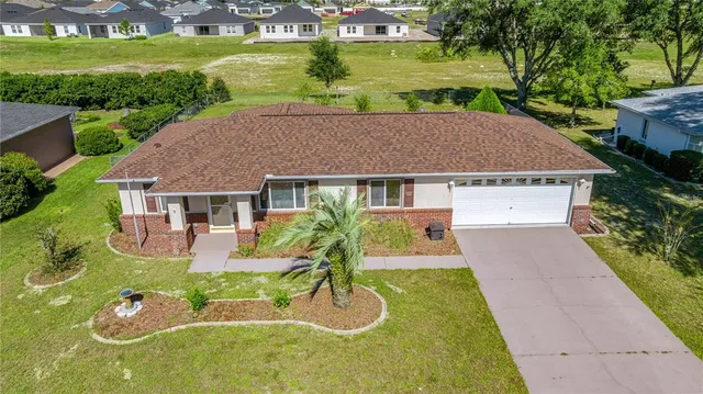 a aerial view of a house with swimming pool garden and patio