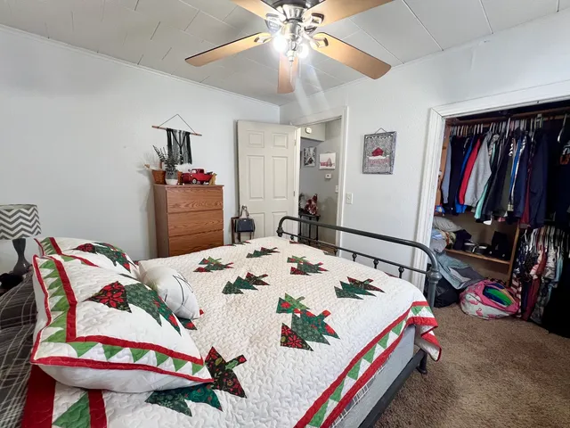 a bedroom with a bed and a chandelier