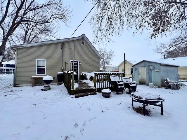 a view of a terrace with chairs and wooden fence
