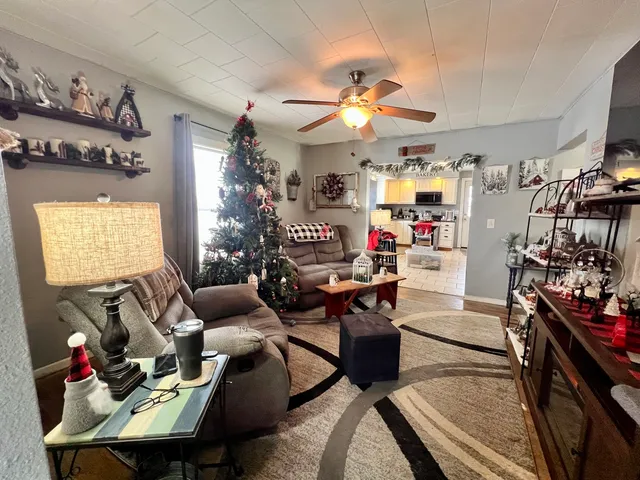 a living room with lots of furniture and a chandelier