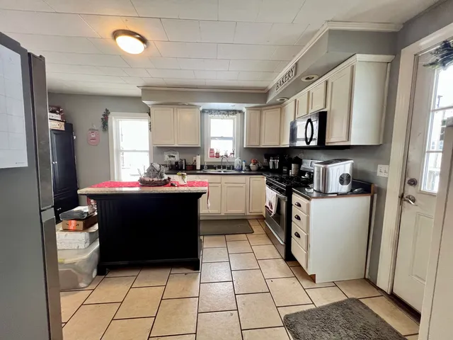 a kitchen with cabinets and window