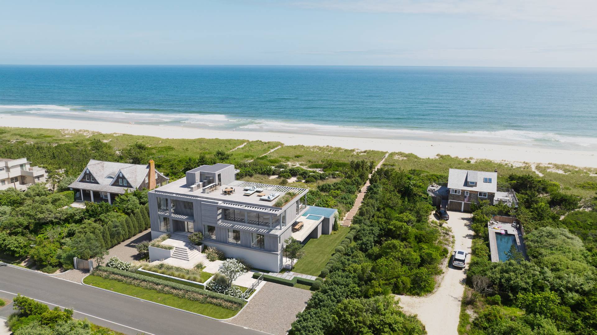 125 Dune Road Bridgehampton, NY 11932 - Photo 1 of 27 a balcony with furniture and a floor to ceiling window