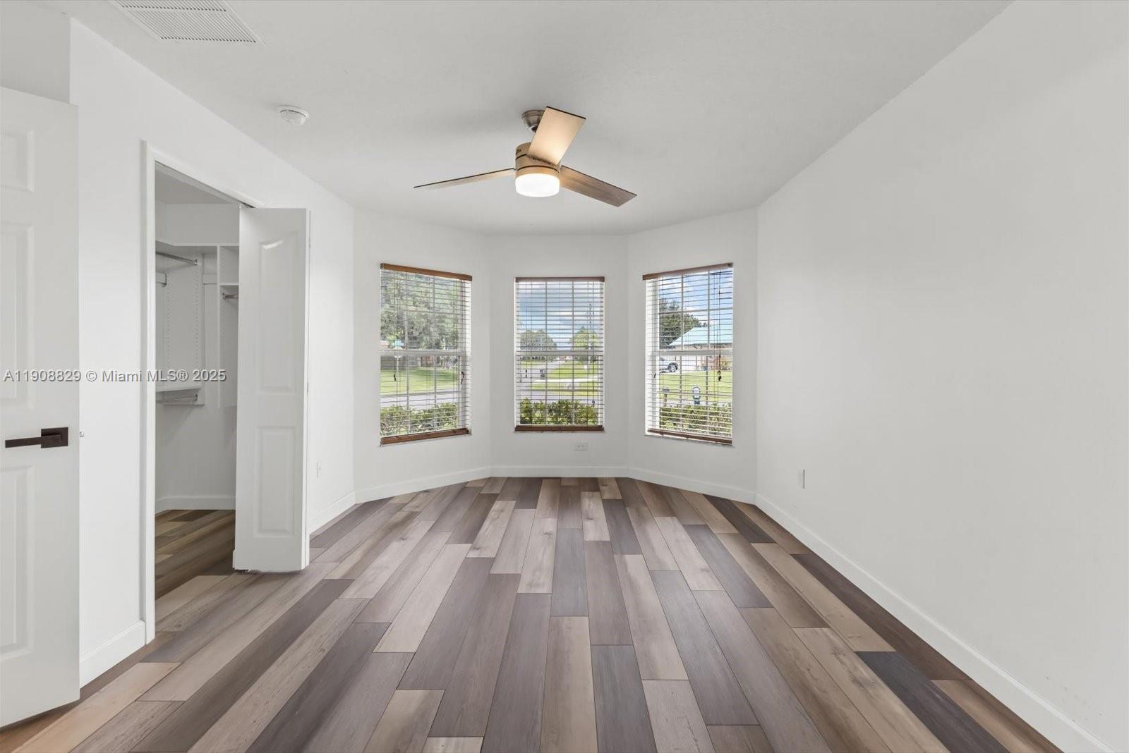 1392 Southwest Sudder Avenue Port St. Lucie, FL 34953 - Photo 13 of 30 wooden floor in an empty room with a window