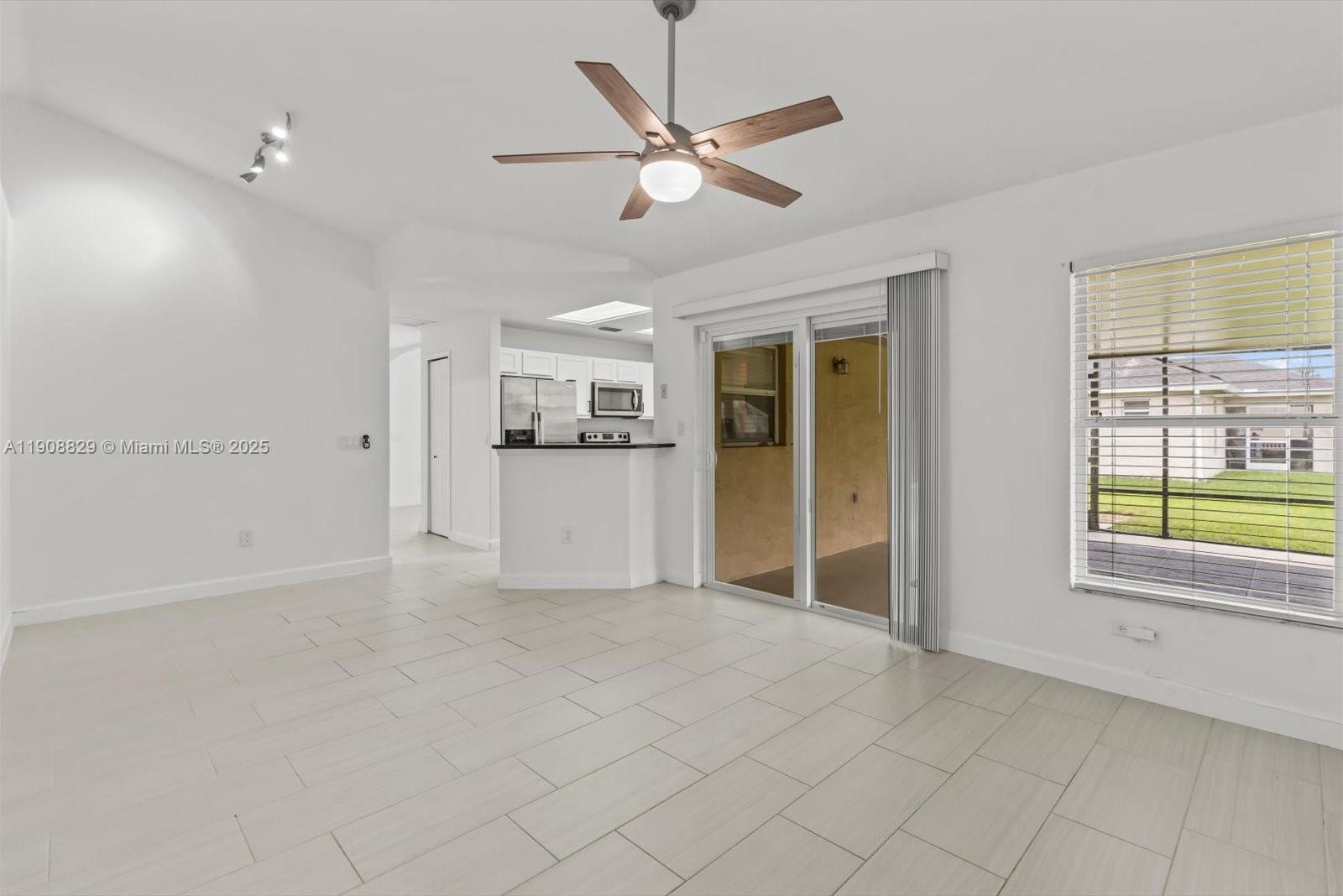 1392 Southwest Sudder Avenue Port St. Lucie, FL 34953 - Photo 17 of 30 a view of a livingroom with a ceiling fan and window