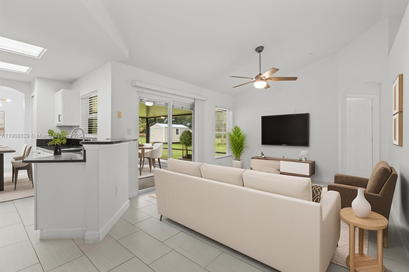 1392 Southwest Sudder Avenue Port St. Lucie, FL 34953 - Photo 18 of 30 a living room with furniture and a flat screen tv