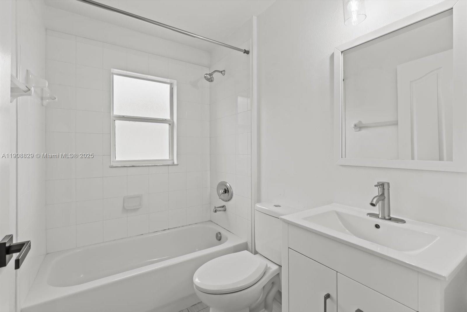 1392 Southwest Sudder Avenue Port St. Lucie, FL 34953 - Photo 21 of 30 a bathroom with a sink toilet and shower