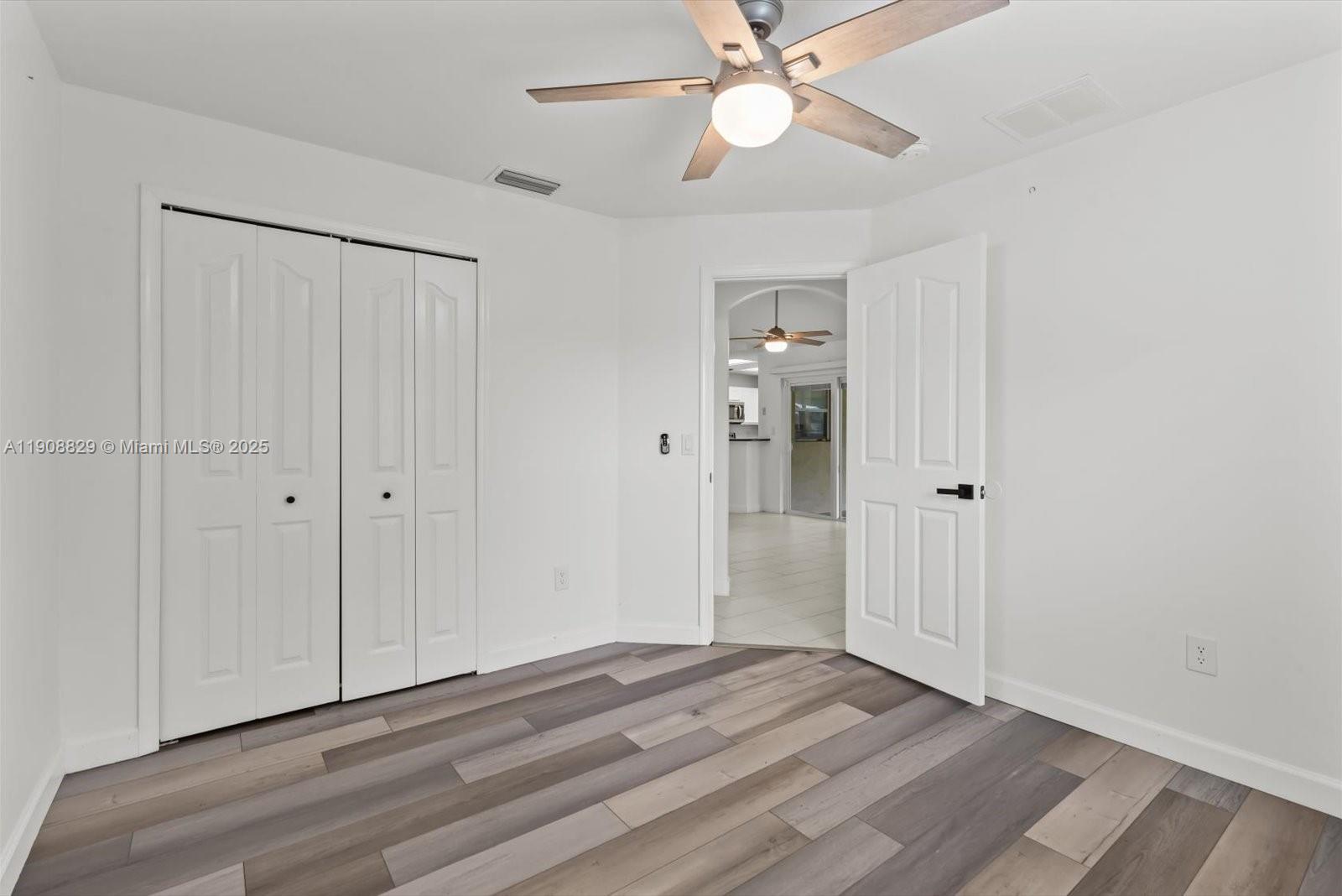 1392 Southwest Sudder Avenue Port St. Lucie, FL 34953 - Photo 23 of 30 a view of an empty room with wooden floor