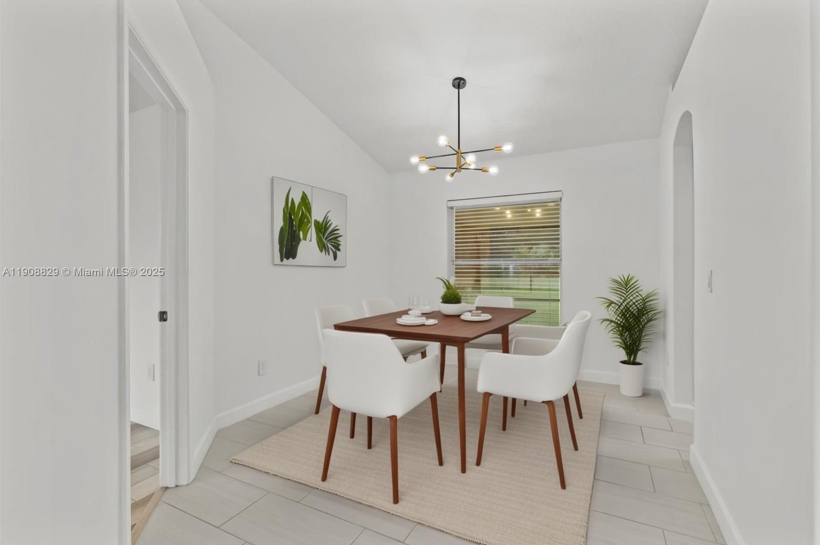 1392 Southwest Sudder Avenue Port St. Lucie, FL 34953 - Photo 4 of 30 a view of a dining room with furniture and chandelier