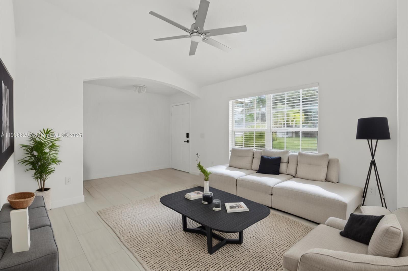 1392 Southwest Sudder Avenue Port St. Lucie, FL 34953 - Photo 6 of 30 a living room with furniture and a large window