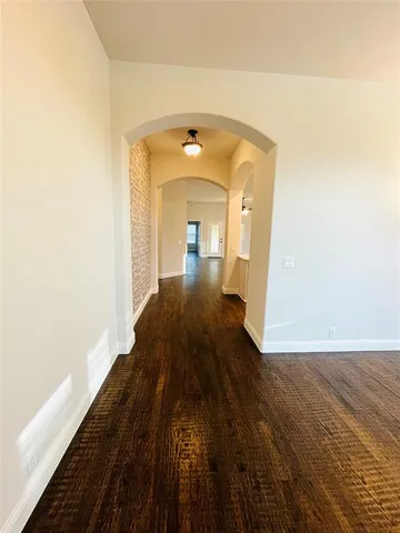 a view of a living room with a wooden floor