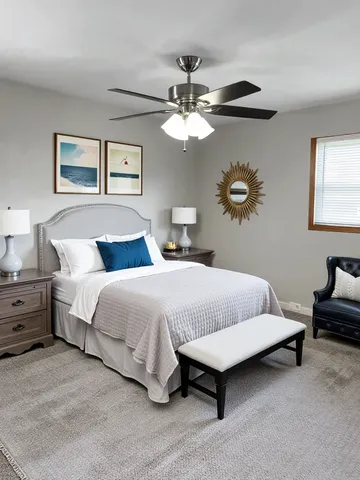 a bedroom with bed and a chandelier