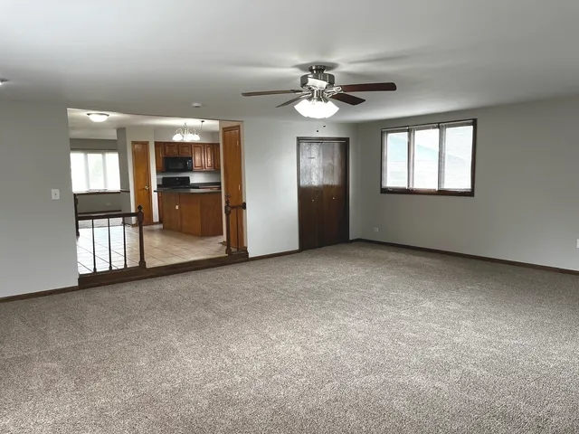 a view of an empty room with window and cabinet
