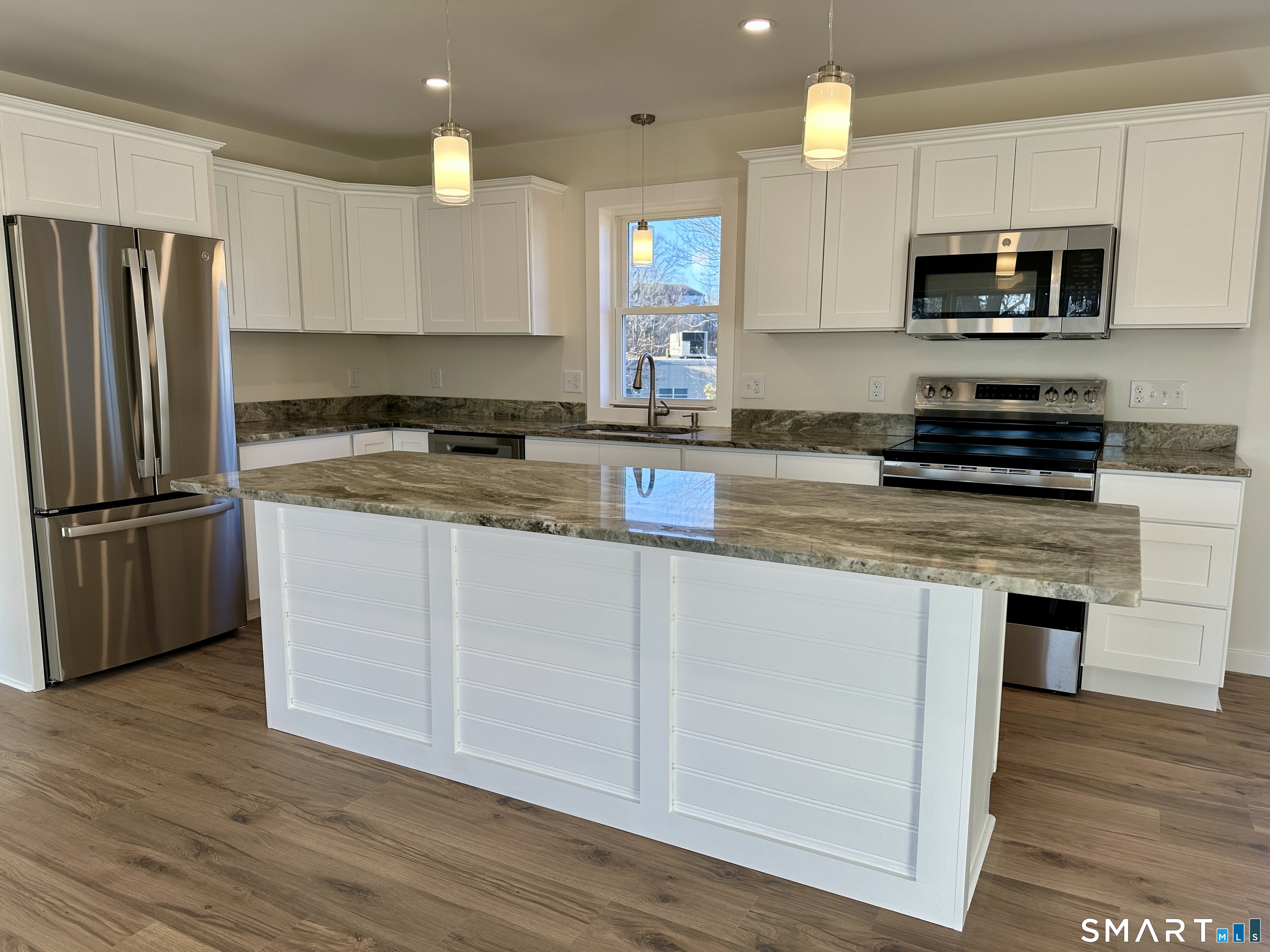 48 Cedar Street, Unit D Branford, CT 06405 - Photo 1 of 27 a kitchen with kitchen island granite countertop a sink cabinets and stainless steel appliances