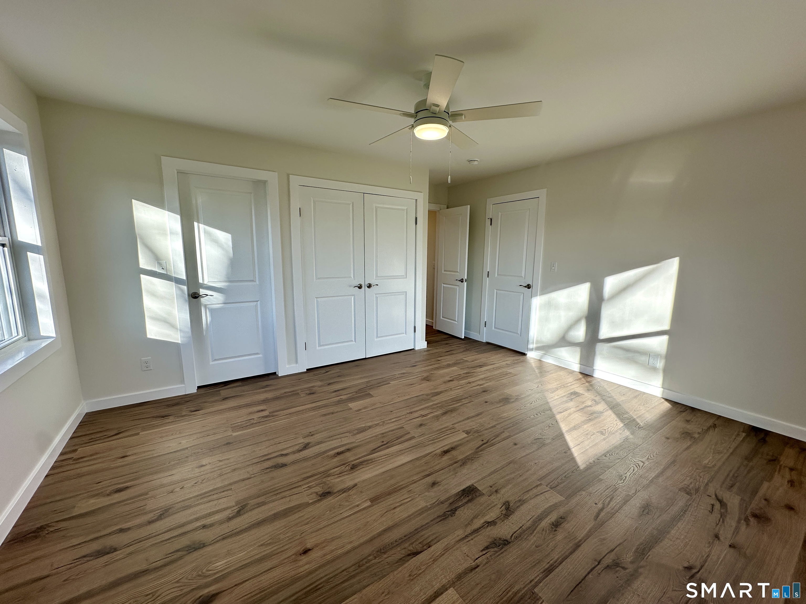 48 Cedar Street, Unit D Branford, CT 06405 - Photo 18 of 27 a view of empty room with wooden floor and fan