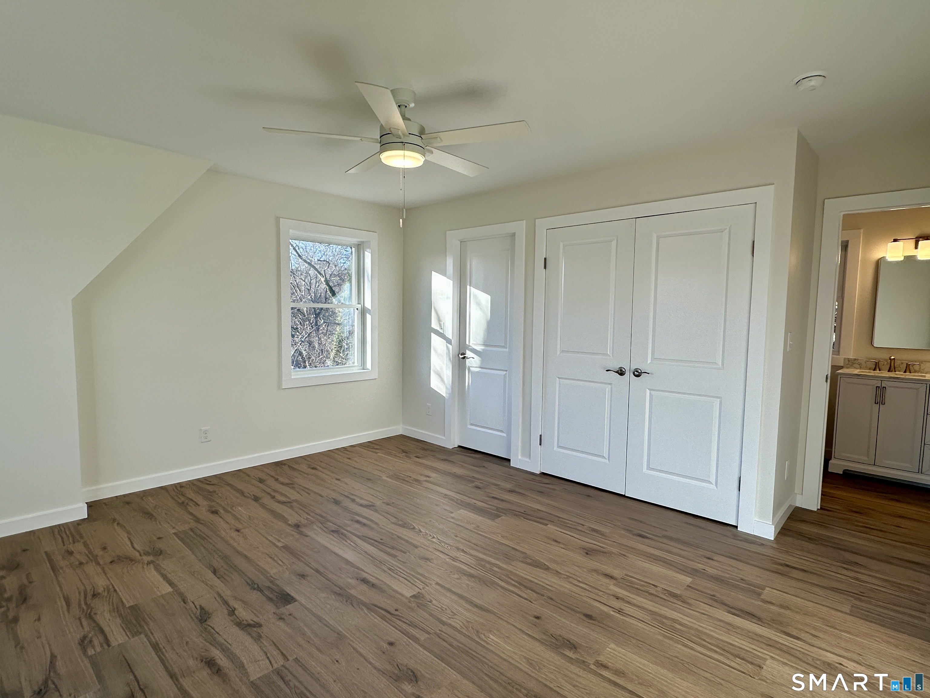 48 Cedar Street, Unit D Branford, CT 06405 - Photo 19 of 27 a view of empty room with wooden floor and fan
