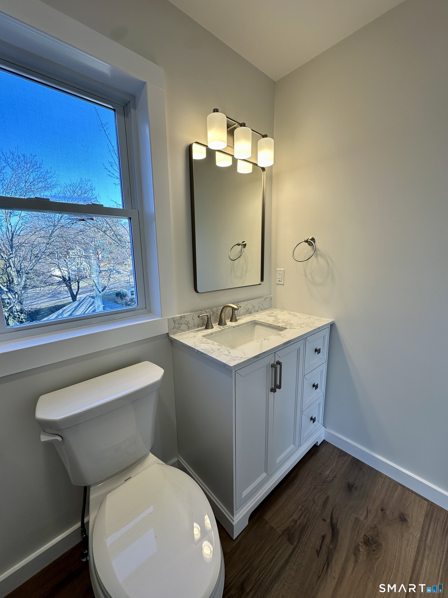48 Cedar Street, Unit D Branford, CT 06405 - Photo 22 of 27 a bathroom with a toilet sink and mirror