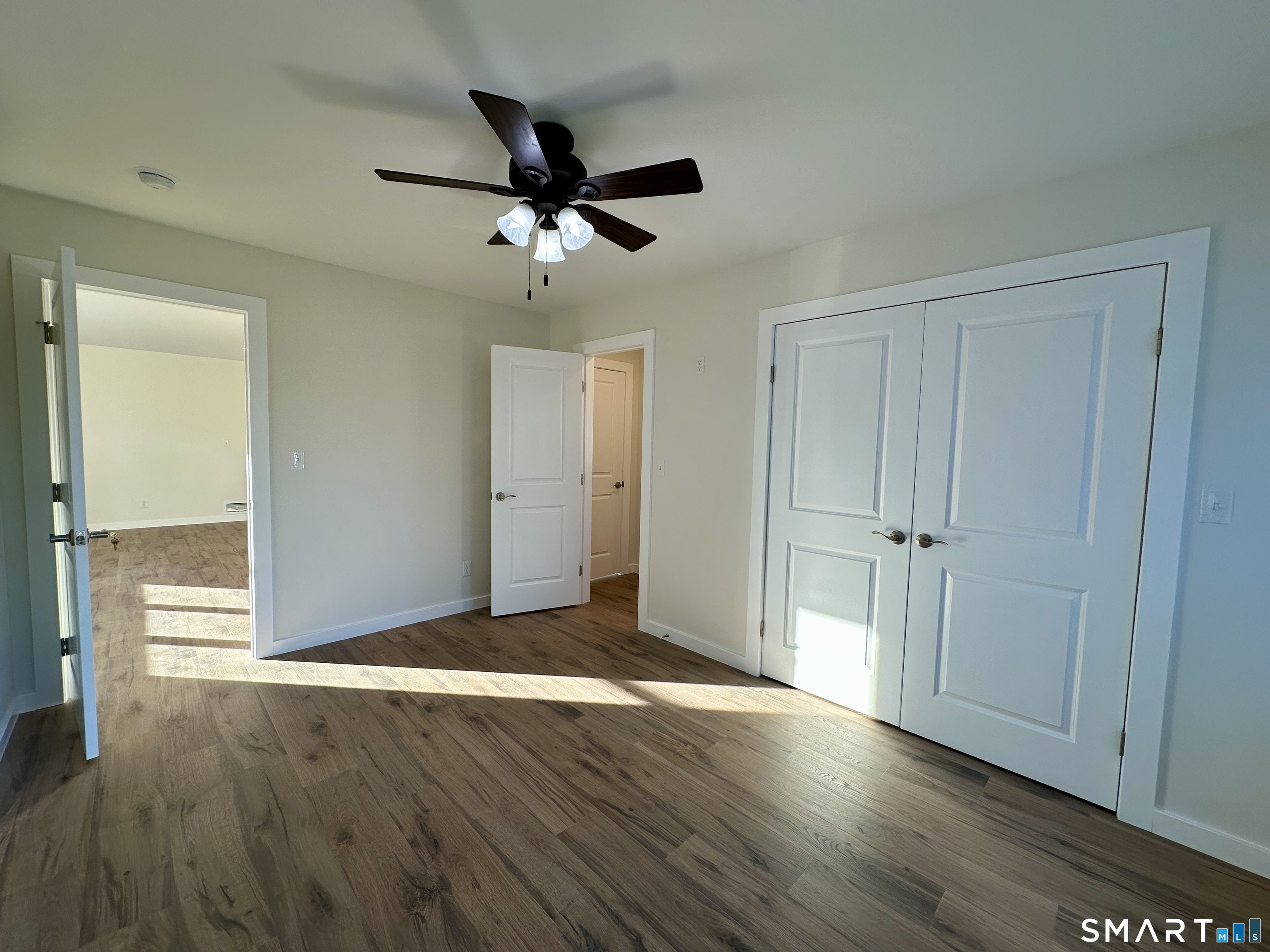 48 Cedar Street, Unit D Branford, CT 06405 - Photo 24 of 27 a view of empty room with wooden floor