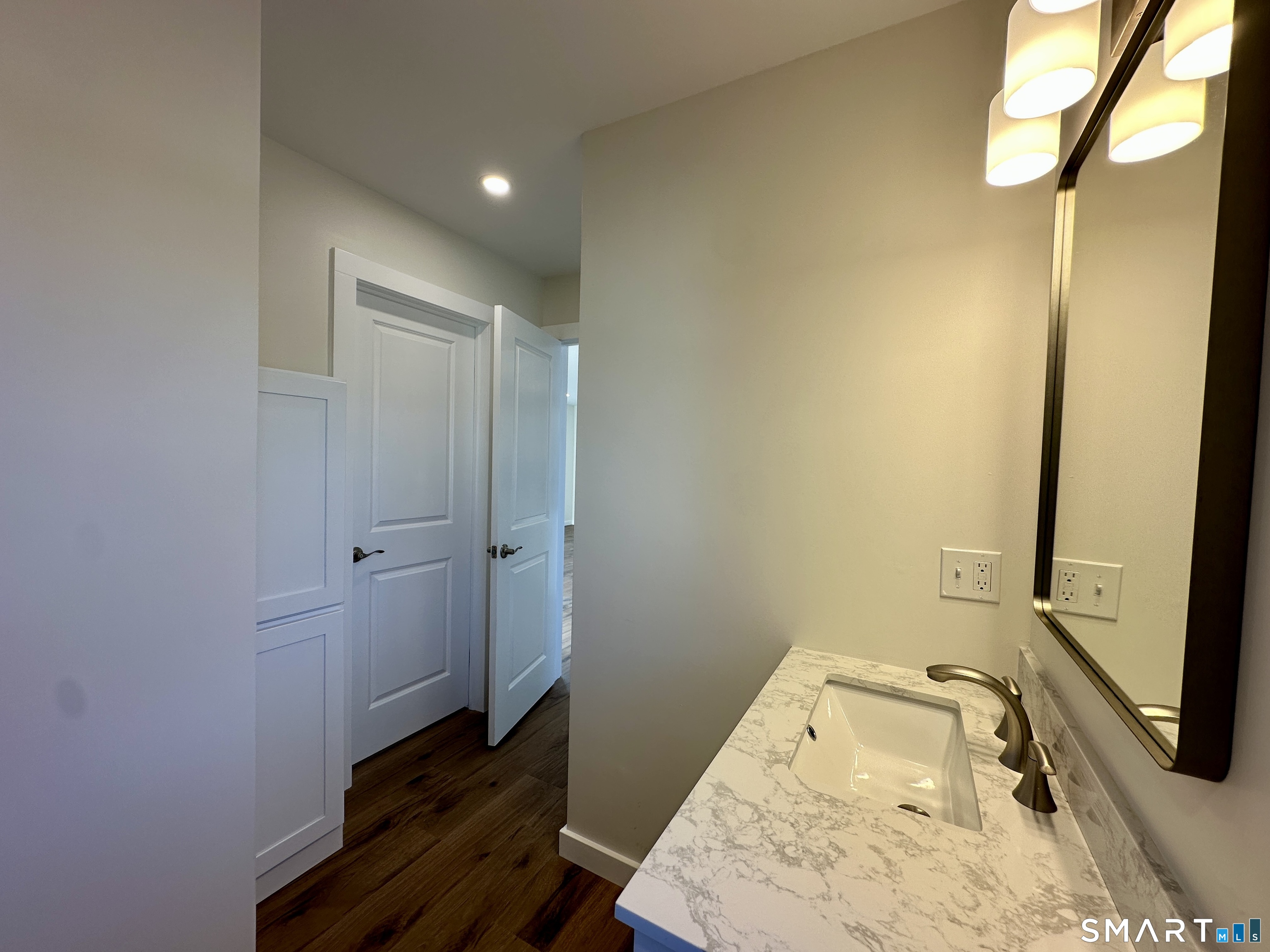 48 Cedar Street, Unit D Branford, CT 06405 - Photo 25 of 27 a bathroom with a tub and sink