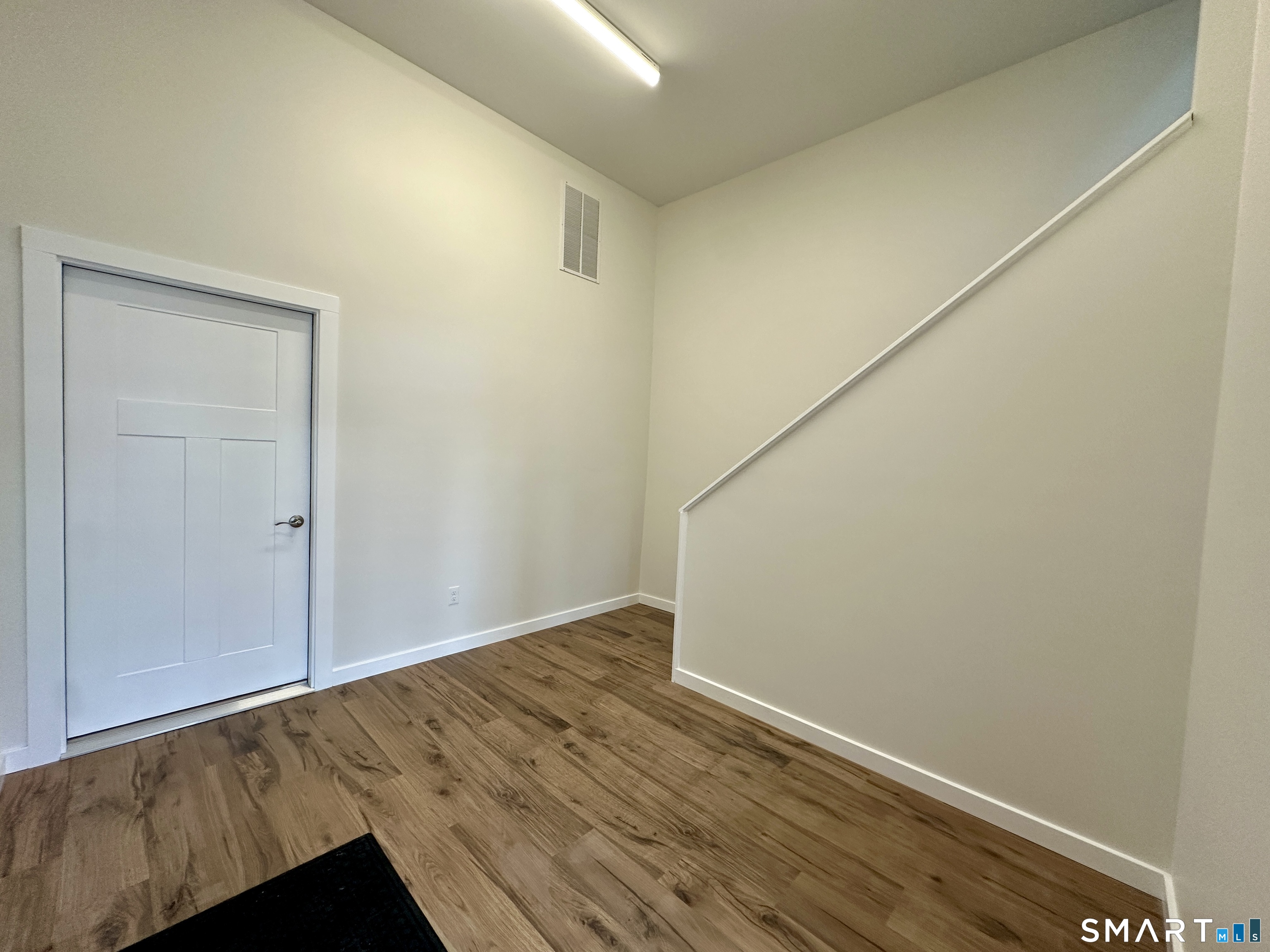 48 Cedar Street, Unit D Branford, CT 06405 - Photo 9 of 27 an empty room with wooden floor