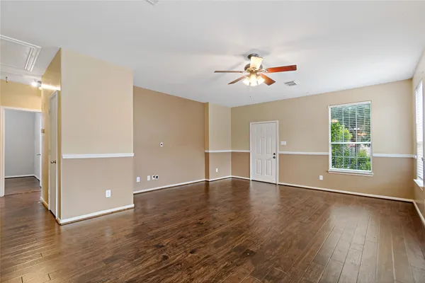 wooden floor in an empty room with a window