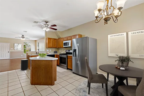a kitchen with kitchen island a counter top space appliances and cabinets