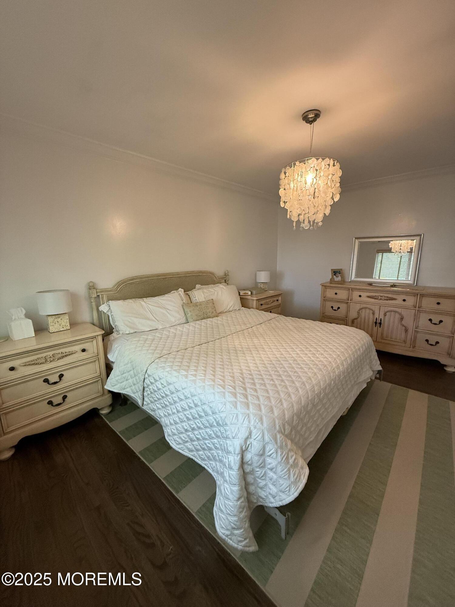 35 Sternberger Avenue, Unit A Long Branch, NJ 07740 - Photo 13 of 18 a bedroom with a bed and a chandelier