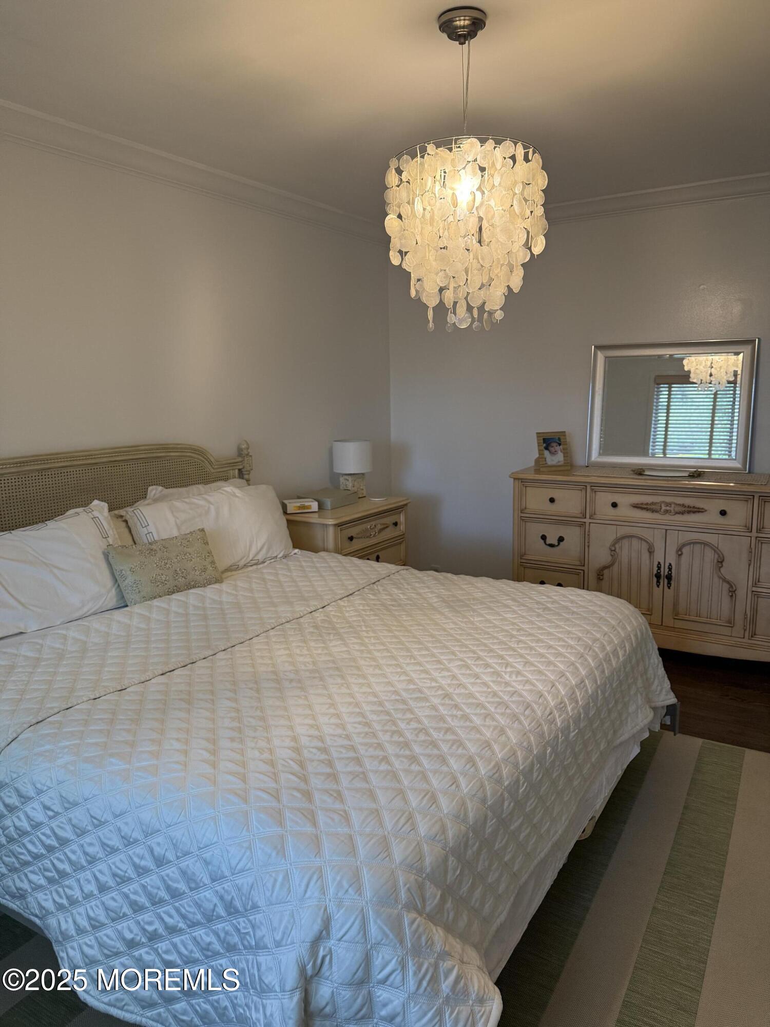 35 Sternberger Avenue, Unit A Long Branch, NJ 07740 - Photo 14 of 18 a bedroom with a bed and chandelier