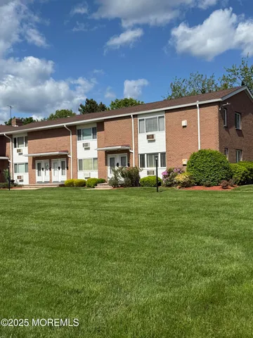 a view of a house with a big yard and large trees