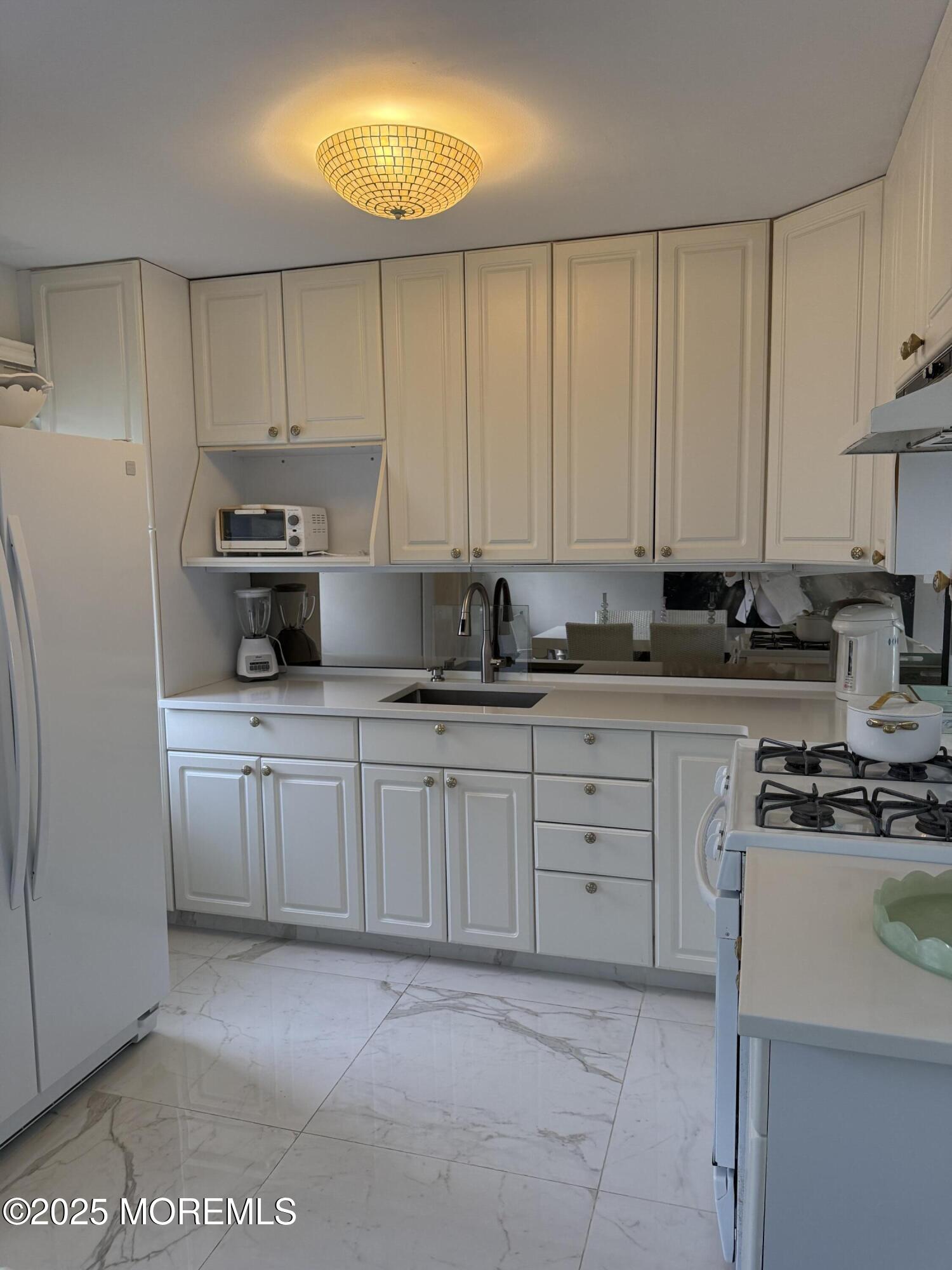 35 Sternberger Avenue, Unit A Long Branch, NJ 07740 - Photo 9 of 18 a kitchen with stainless steel appliances granite countertop a stove a sink and a refrigerator